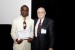 Dr. Nagib Callaos, General Chair, giving Mr. Kester O. Omoregie the best paper award certificate of the session "Enabling Intelligent Planet via Informatics and Cybernetics ." The title of the awarded paper is "Modeling State Space Search Technique for a Real World Adversarial Problem Solving."